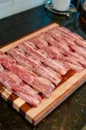 American Wagyu short ribs with visible marbling and bone-in cross-cut presentation.